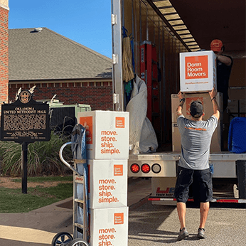 Out on the field delivering boxes to the student's new dorm room for the upcoming semester.